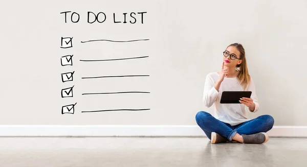 To do list with woman using a tablet