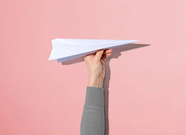 Person holding a paper airplane