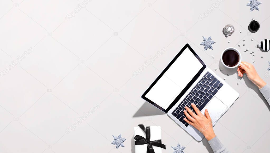 Christmas ornaments with person using a laptop computer