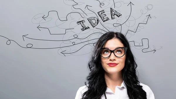 Brainstorming idea arrows with young businesswoman — Stock Photo, Image