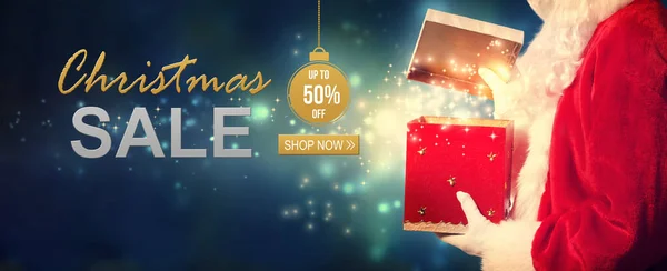 Christmas sale message with Santa opening a gift box — Stock Photo, Image