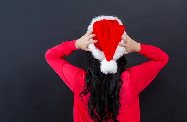 Young woman with a Santa hat