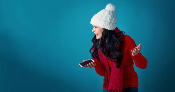 Ung kvinna med jultema med hjälp av sin telefon — Stockfoto