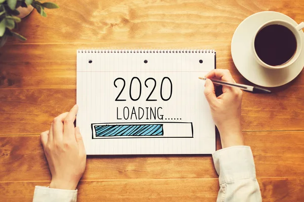 Loading new year 2020 with a person holding a pen — Stock Photo, Image