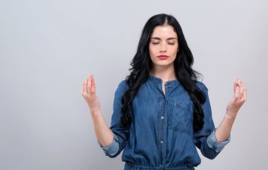 Meditasyon yapan genç bir kadın.