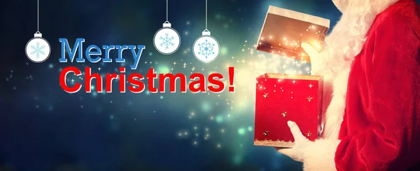 Feliz mensaje de Navidad con Santa apertura de una caja de regalo —  Fotos de Stock