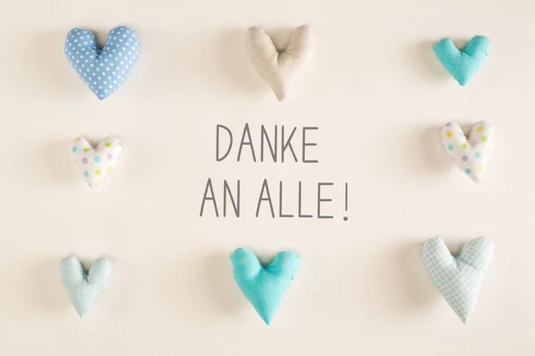 Danke an alle - Thank you all in German language with blue heart cushions