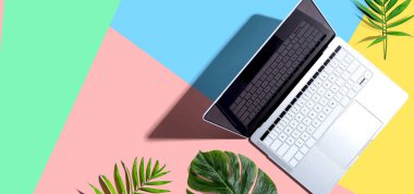 Laptop computer with tropical plants