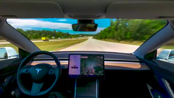 Person driving a new Tesla Model 3 on autopilot — Stock Video