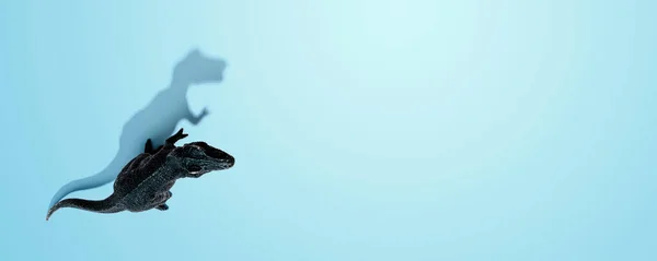 Игрушка тираннозавра с тенью — стоковое фото