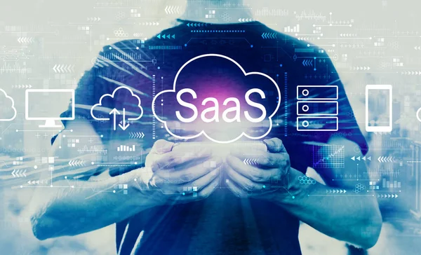 SaaS - software as a service concept with man holding smartphone