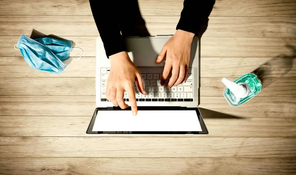 El dezenfektanı ve maskeli dizüstü bilgisayar.