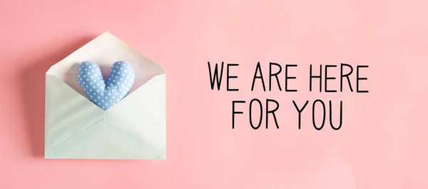 We are Here for You message with a heart cushion in an envelope — Stock Photo, Image