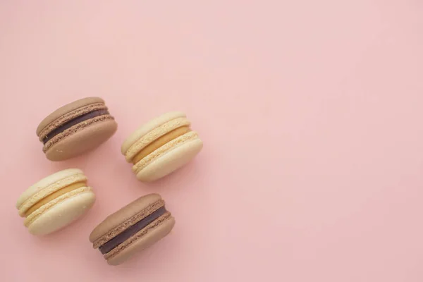 composition of delicious macaroons on pink background