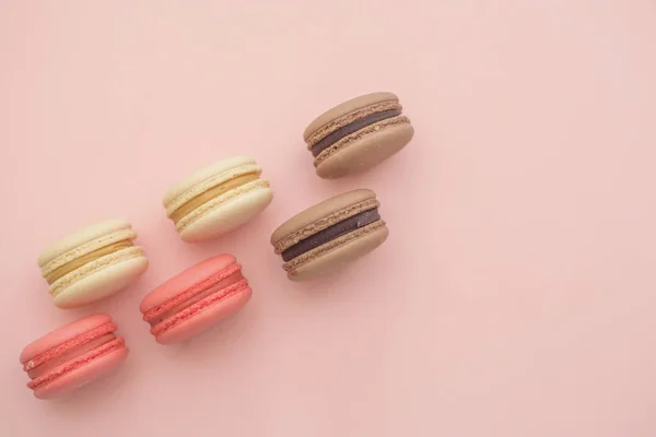 composition of delicious macaroons on pink background