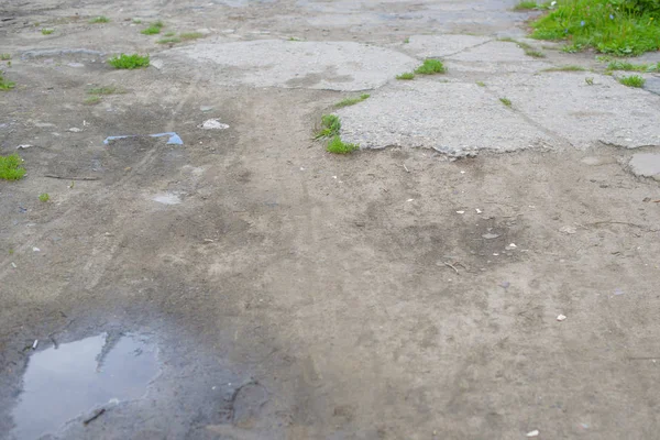 green concrete floor with puddles