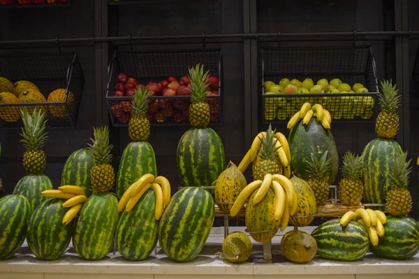 pineapples, bananas and watermelons at market