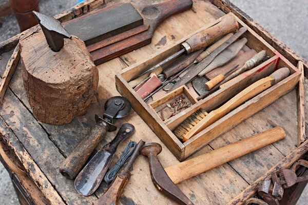 work table with old tools of the artisan shoemaker