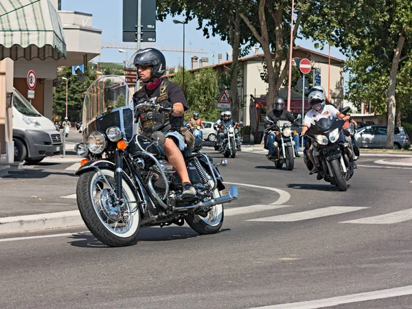 biker riding a vintage italian motorcycle in rally 8th Weekend Moto Guzzi on July 15, 2012 in San Vittore (FC) Italy