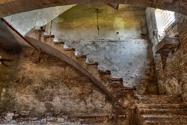 dark basement with stairs and window of an old abandoned country house