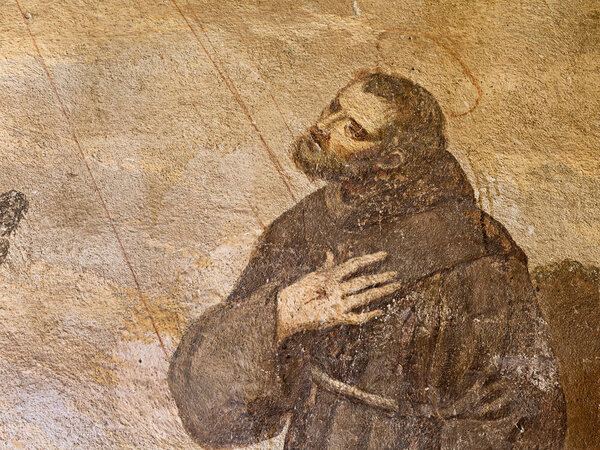 ancient fresco of St. Francis of Assisi in the cloister of an italian convent 