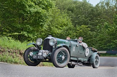 an old racing car Bentley 4 1/2 Litre Supercharged (1930) runs in rally Mille Miglia 2013, the famous italian historical race (1927-1957) on May 18, 2013 in Passo della Futa (FI) Italy  clipart