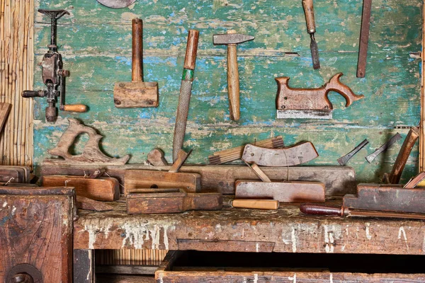 woodworking tools of an ancient carpentry - old bench of craftsman workshop with carpenter\'s equipment