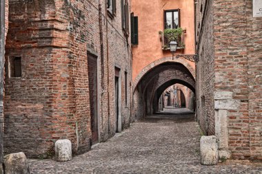 Ferrara, Emilia Romagna, Italy: the picturesque arched alley Via delle Volte, ancient medieval street clipart