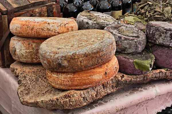 sheep milk cheese from Sardinia, Italy, on a piece of cork - traditional artisan food product in Italian market
