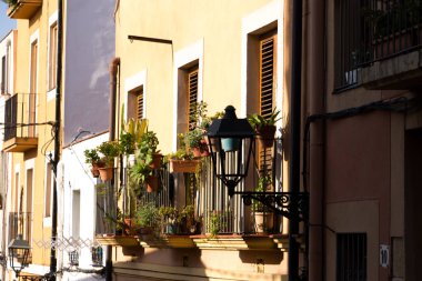 İspanya Tatil serisi. Tarragona, sokakta konuda seyahat, yaz, tatil yeşil bitkiler ile sarı bina balkon.