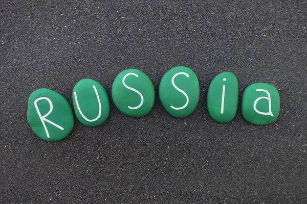 Russia, country name with green colored stones over black volcanic sand