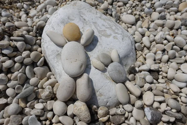 Sunbathing and relax concept with pebbles composition over a rock