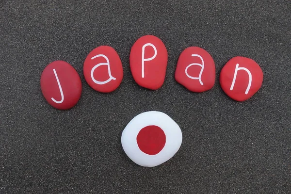 Japan country, text design with red colored stones over black volcanic sand