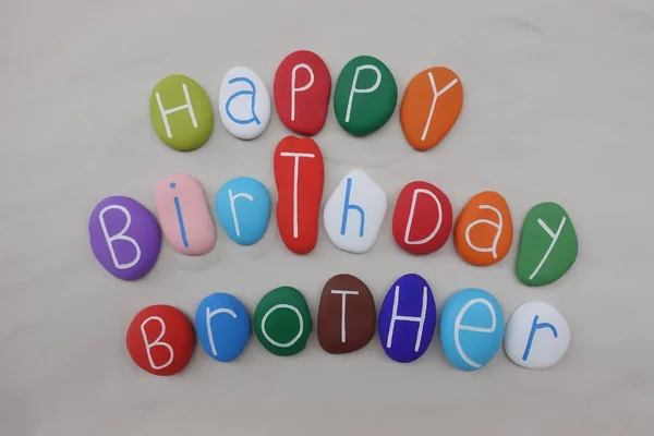 Happy Birthday Brother with colored stones over white sand