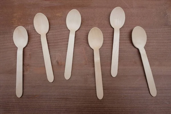 Wooden spoons over wooden board