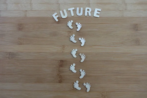 Future steps, future life, conceptual and creative idea with wooden miniature feet