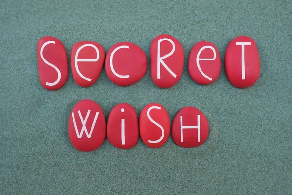 Secret Wish, secret message composed with red colored stone letters