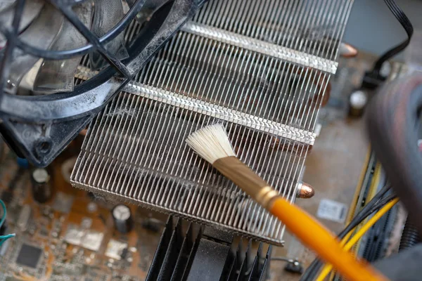 desktop computer dust cleaning with tassel. cpu cooling radiator system with dust and web.