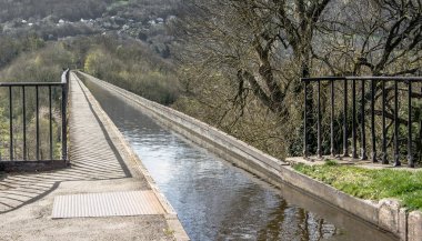 A view across the narrow Pontcysyllte Aqueduct which carries the Llangollen Canal across the River Dee in the Vale of Llangollen in north east Wales. clipart