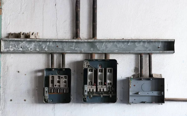 Damaged Electrical switchport  control panel on a white wall