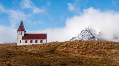 Hellnar church and the volcano Snaefellsjokull, covered in snow in Snaefellsnes peninsula of Western Iceland. clipart