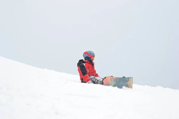 A small child fell off a snowboard