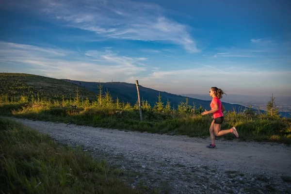 Woman running in mountains. Woman trail runner. Szczyrk, Beskidy Mountains, Poland