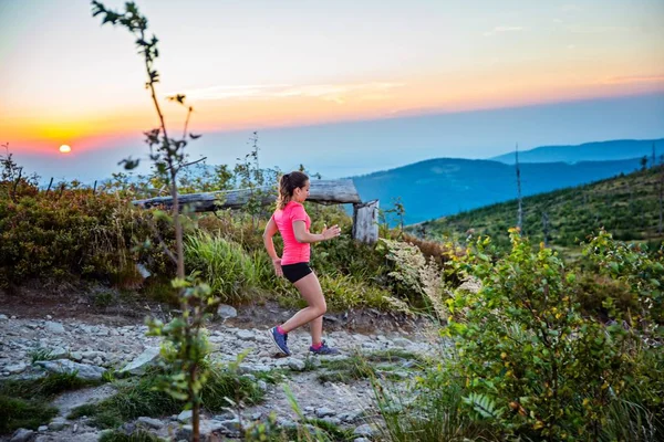 Woman trail running in mountains. Szczyrk, Beskidy Mountains, Silesian Beskid, Poland