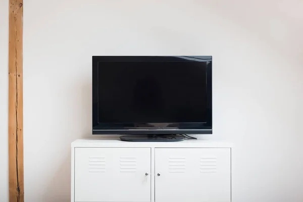 Modern flat lcd television set on white cabinet