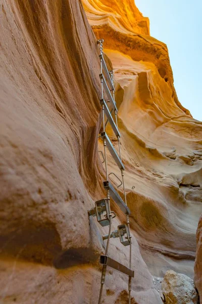 Metal ladder attached to rocks in Red Canyon. Red Canyon is one of Israel\'s most beautiful hiking trails