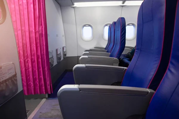 First row of seats in a passenger plane. Passenger plane interior, economy class