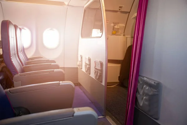 First row of seats in a passenger plane. Passenger plane interior, economy class