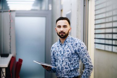 Businessman with tablet in his office. Man working in office