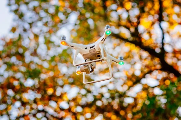 Unmanned aerial vehicle. White drone quadrocopter in flight